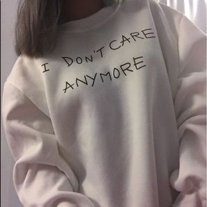 White “I don’t care” sweater gun sleeve
